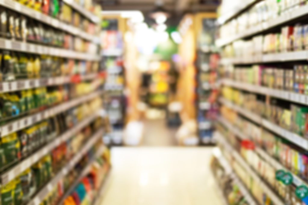 Grocery Store Aisle Abstract Blurred Background With Products On Shelves